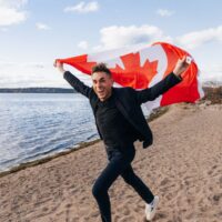 James Mullinger Running With Canadian Flag